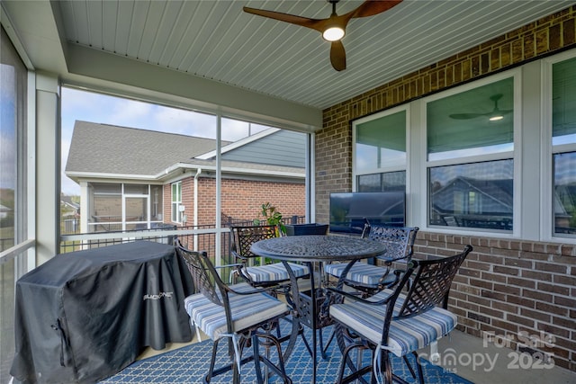 sunroom / solarium featuring ceiling fan