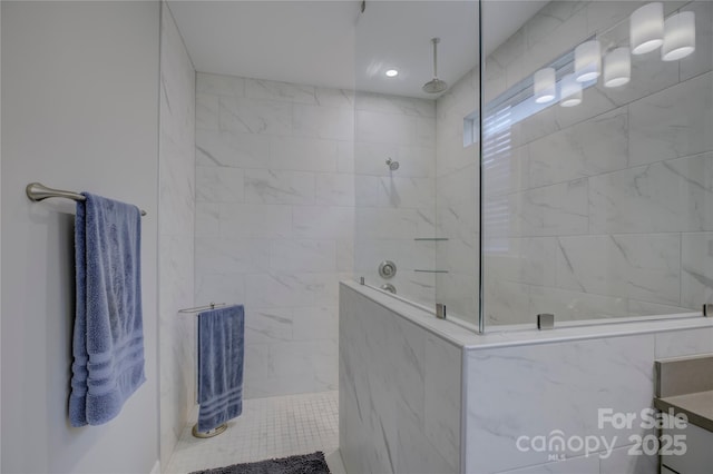 bathroom with vanity and tiled shower