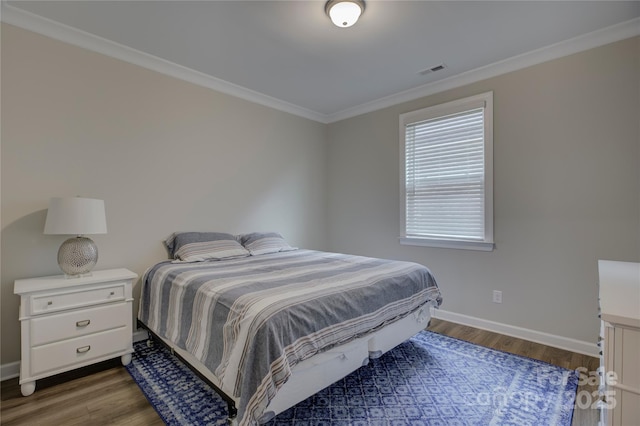 bedroom featuring ornamental molding and dark wood-type flooring