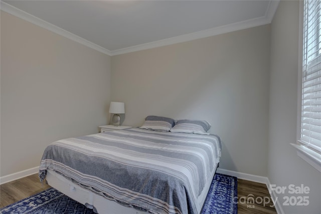 bedroom featuring wood-type flooring, crown molding, and multiple windows