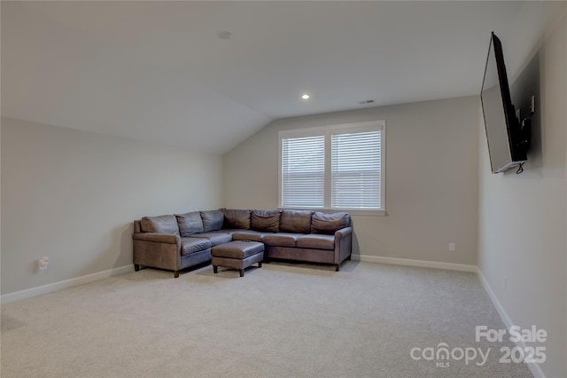 living room with light colored carpet and vaulted ceiling