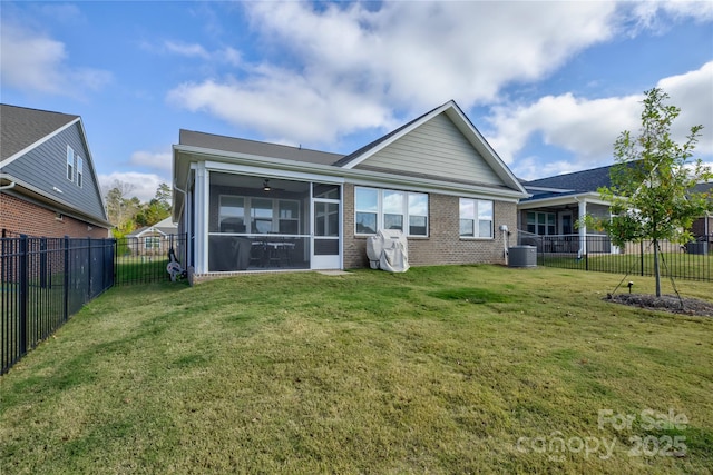 back of house with a sunroom and a lawn