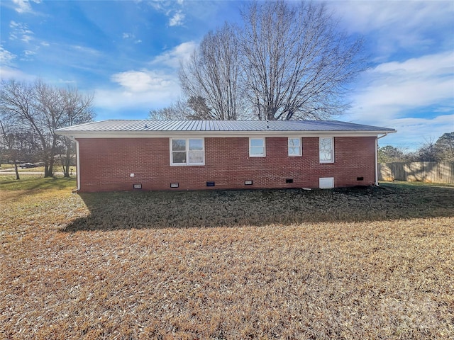 view of side of home featuring a lawn