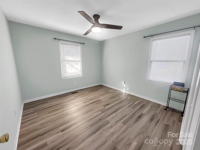 empty room featuring ceiling fan and light hardwood / wood-style floors