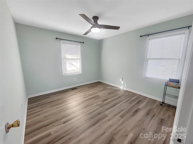 spare room featuring ceiling fan and light hardwood / wood-style flooring