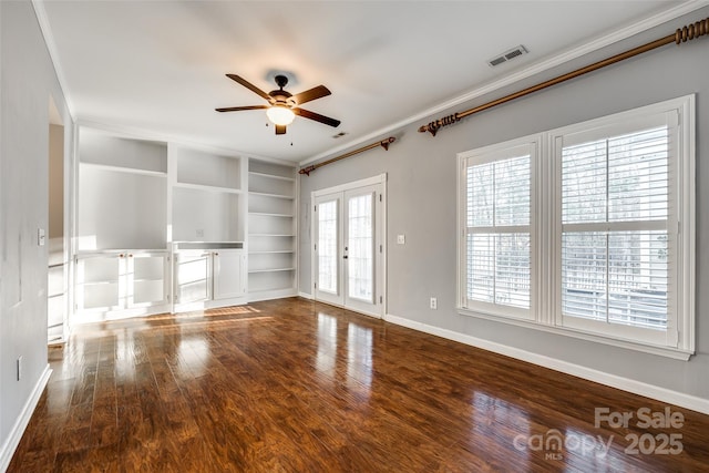 unfurnished living room featuring french doors, built in shelves, ceiling fan, ornamental molding, and wood-type flooring