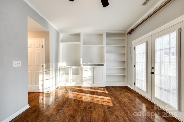 unfurnished living room featuring dark hardwood / wood-style flooring, french doors, and built in shelves