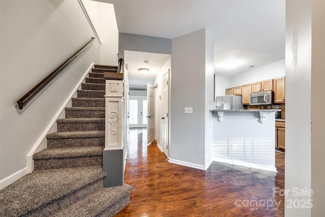 stairway featuring hardwood / wood-style flooring