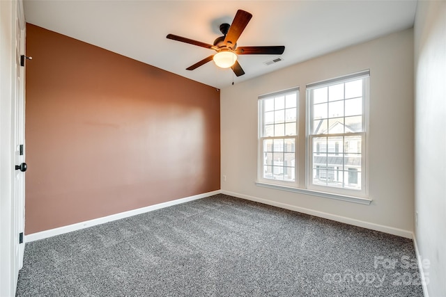 empty room featuring carpet flooring and ceiling fan