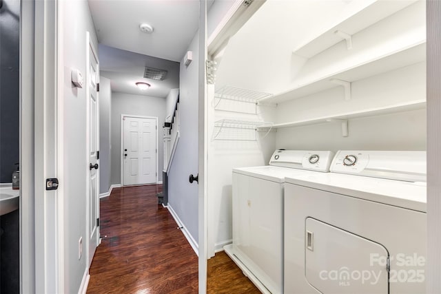 laundry room featuring separate washer and dryer and dark wood-type flooring