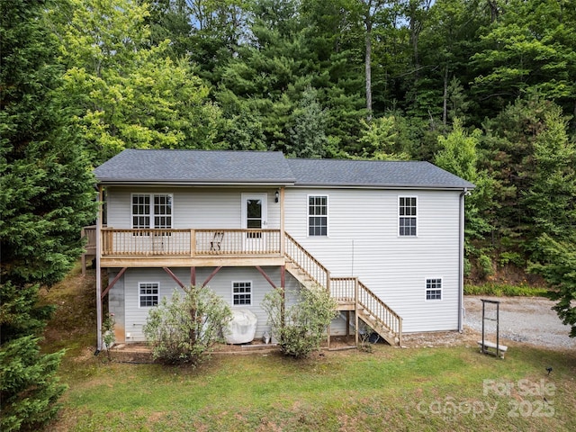 rear view of house with a yard and a deck