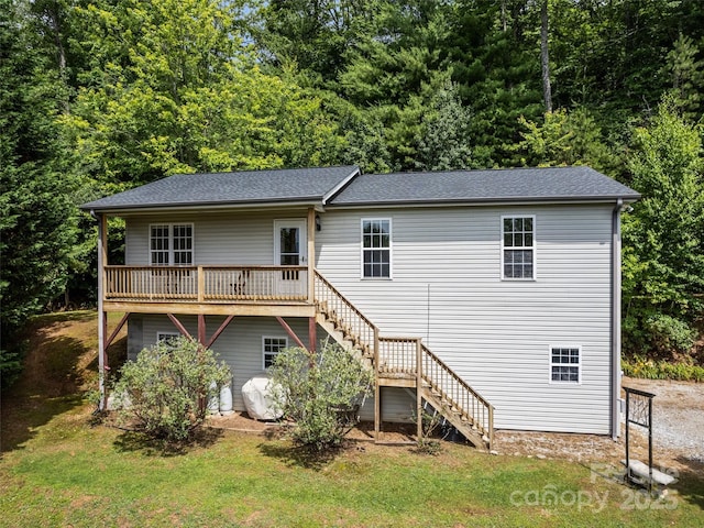 back of house with a yard and a wooden deck