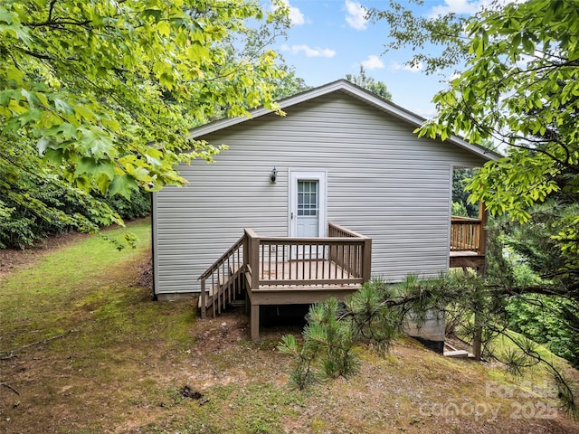 rear view of house featuring a deck