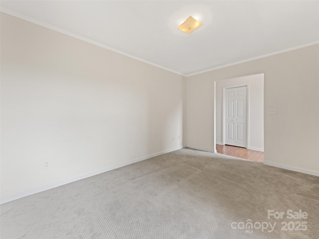 unfurnished room featuring ornamental molding and light carpet