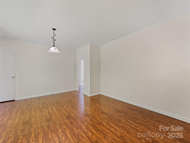 spare room with wood-type flooring