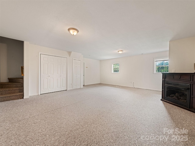 unfurnished living room featuring carpet floors