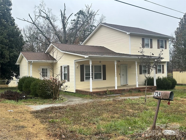 view of front of home featuring covered porch and a front yard