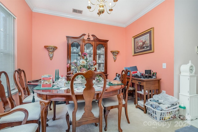 dining room with light colored carpet, ornamental molding, and an inviting chandelier