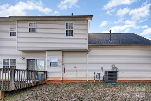 rear view of house with central AC and a deck