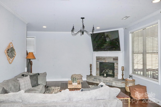 living room with plenty of natural light, crown molding, and a stone fireplace