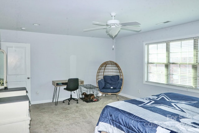 bedroom featuring light colored carpet and ceiling fan