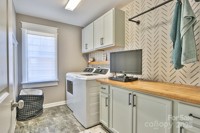 laundry area with cabinets and washing machine and clothes dryer