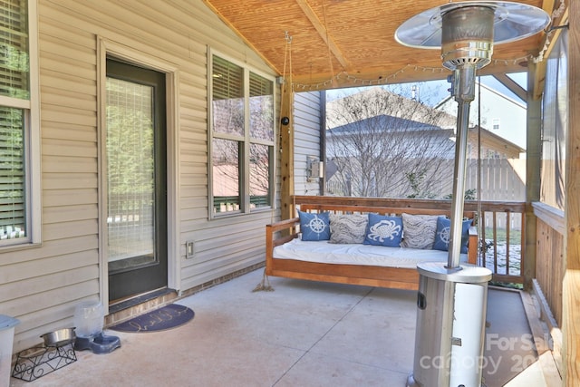 sunroom with vaulted ceiling and wooden ceiling