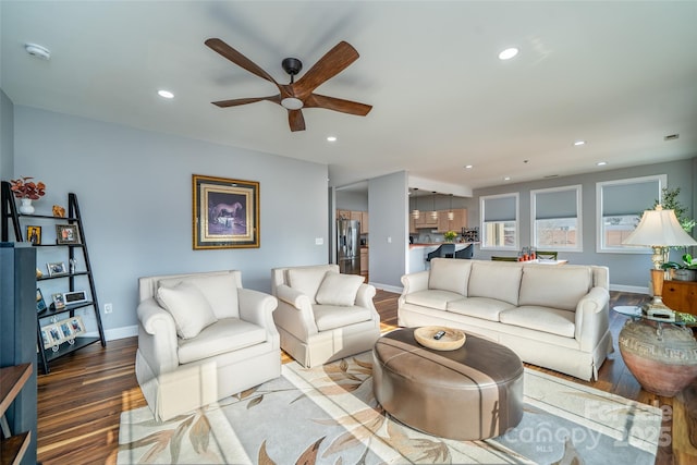 living room with light hardwood / wood-style flooring and ceiling fan