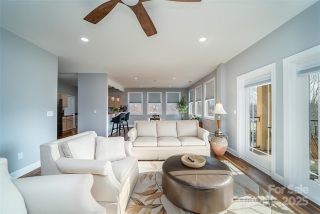 living room with ceiling fan and light hardwood / wood-style floors