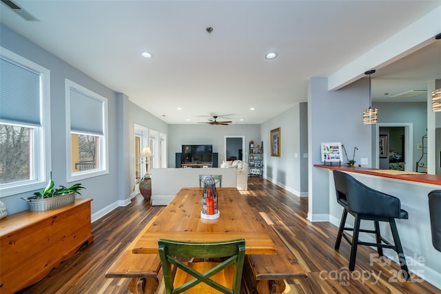 dining space featuring ceiling fan and dark hardwood / wood-style flooring