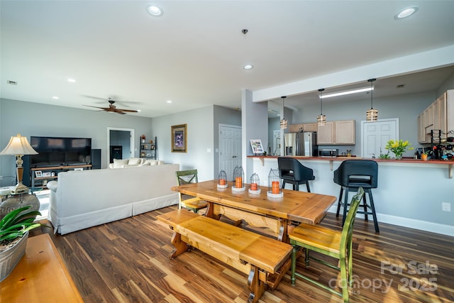 dining space with dark wood-type flooring and ceiling fan