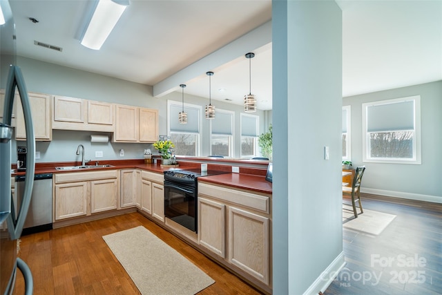 kitchen with sink, light brown cabinets, black / electric stove, dishwasher, and pendant lighting