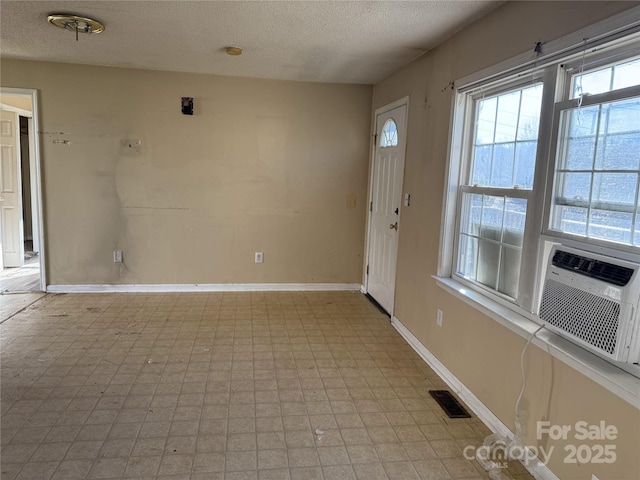 foyer with cooling unit and a textured ceiling