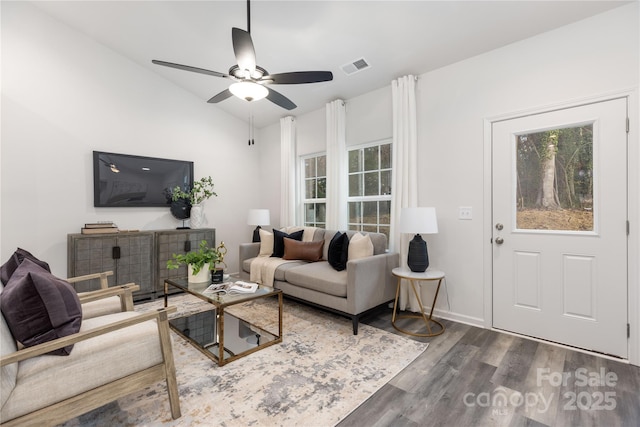 living room featuring ceiling fan, dark wood-type flooring, and vaulted ceiling