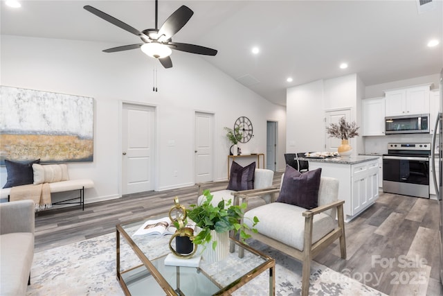 living room featuring ceiling fan, high vaulted ceiling, and dark hardwood / wood-style floors