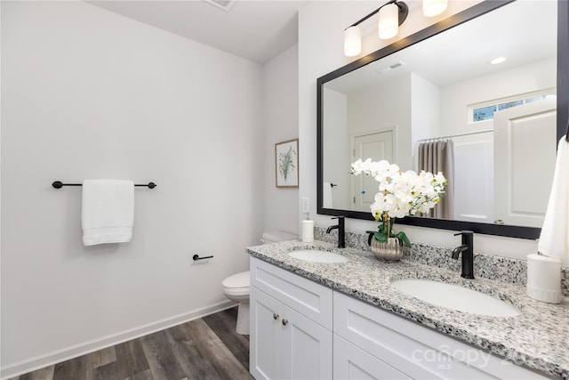 bathroom with vanity, toilet, and wood-type flooring