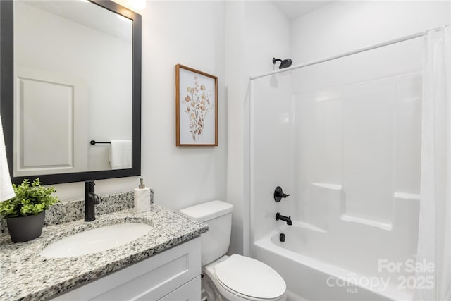 full bathroom featuring vanity, shower / bath combo, and toilet