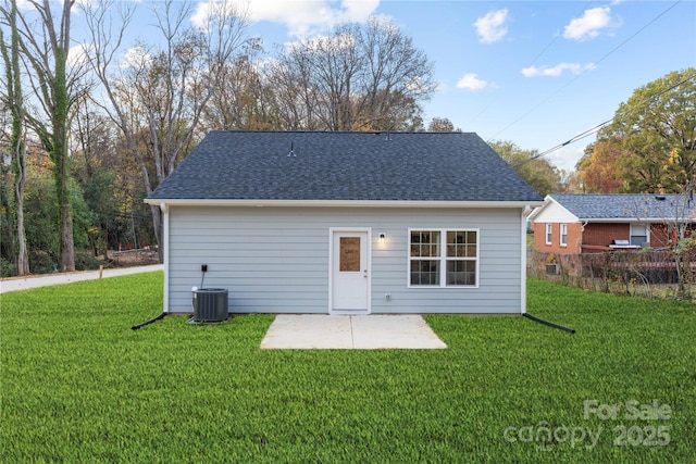 rear view of house featuring a patio area, a yard, and central AC