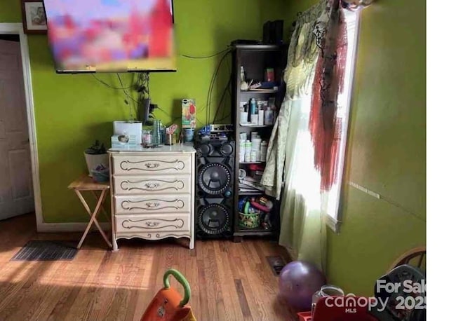 bedroom with hardwood / wood-style floors