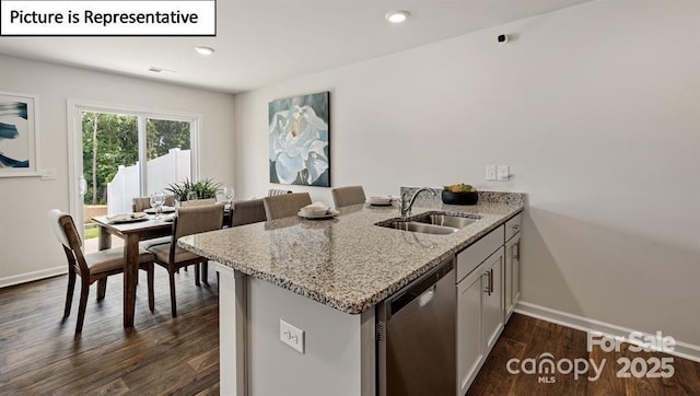 kitchen with dishwasher, white cabinets, sink, light stone countertops, and dark hardwood / wood-style flooring