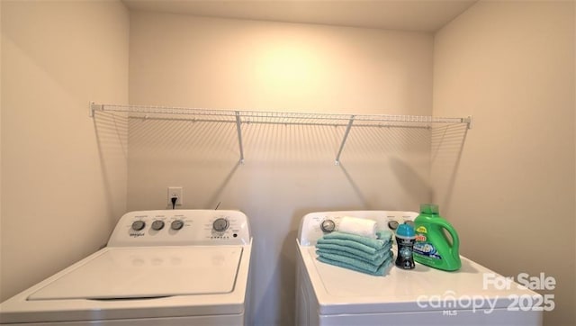 clothes washing area featuring washing machine and clothes dryer