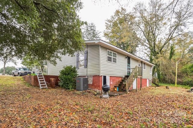 view of side of property featuring central air condition unit