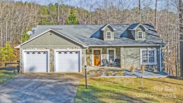 view of front of home with covered porch, a garage, and a front yard