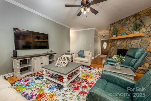 living room with a fireplace, hardwood / wood-style flooring, ceiling fan, and ornamental molding