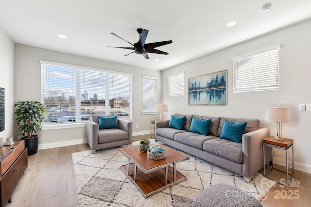 living room with light wood-type flooring and ceiling fan