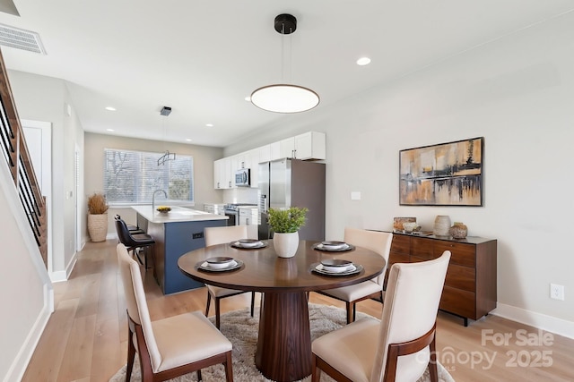 dining space featuring light hardwood / wood-style floors