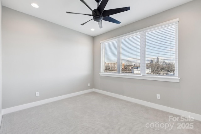 carpeted empty room featuring ceiling fan