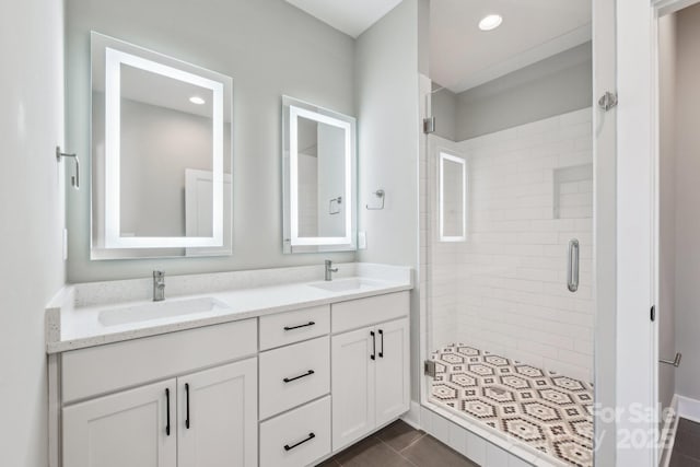 bathroom featuring a shower with door, tile patterned flooring, and vanity