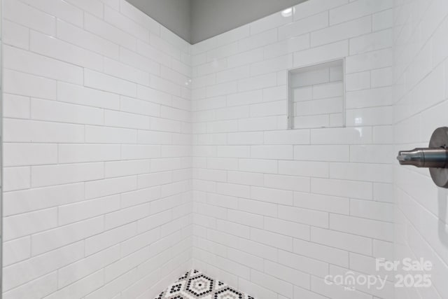 bathroom with tiled shower