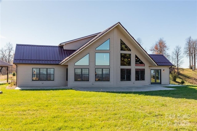 rear view of property featuring a lawn and a patio area